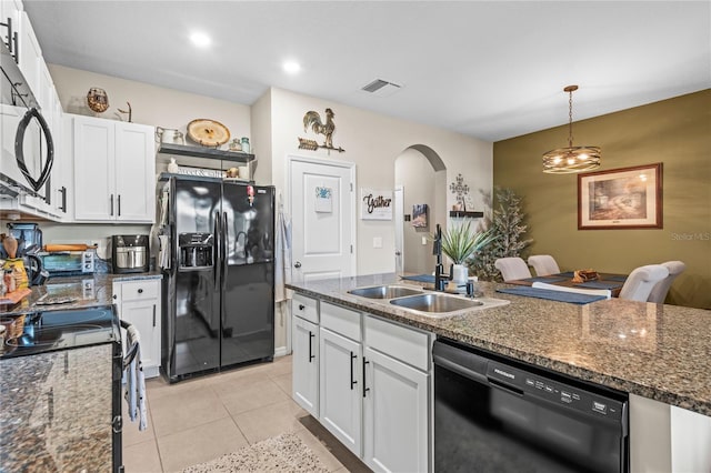 kitchen with black appliances, white cabinetry, and sink