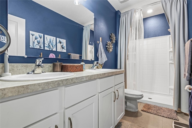 bathroom with tile patterned flooring, vanity, a shower with shower curtain, and toilet