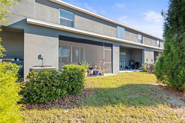 rear view of property featuring a lawn