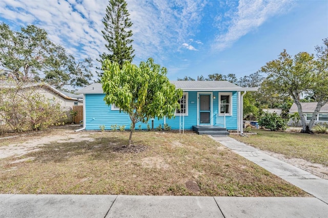 bungalow with a front yard and a porch