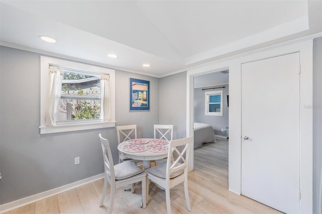 dining room featuring vaulted ceiling and light hardwood / wood-style flooring