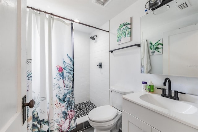 bathroom with toilet, tile patterned flooring, walk in shower, and vanity