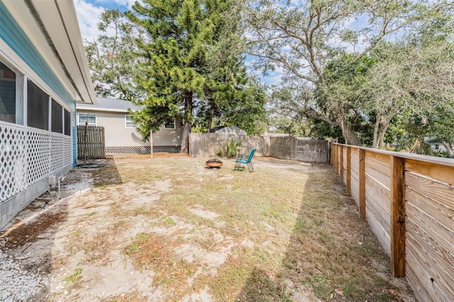 view of yard with a fire pit