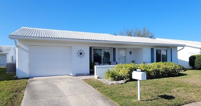 single story home featuring covered porch, central AC unit, a front yard, and a garage