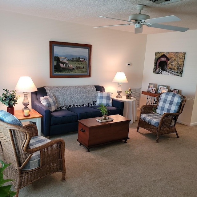 living room with a textured ceiling, ceiling fan, and carpet floors