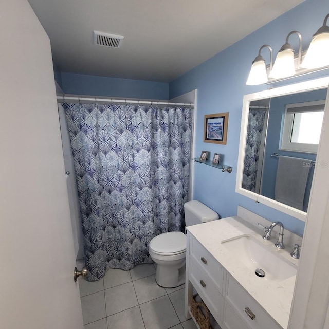 bathroom with tile patterned flooring, vanity, and toilet