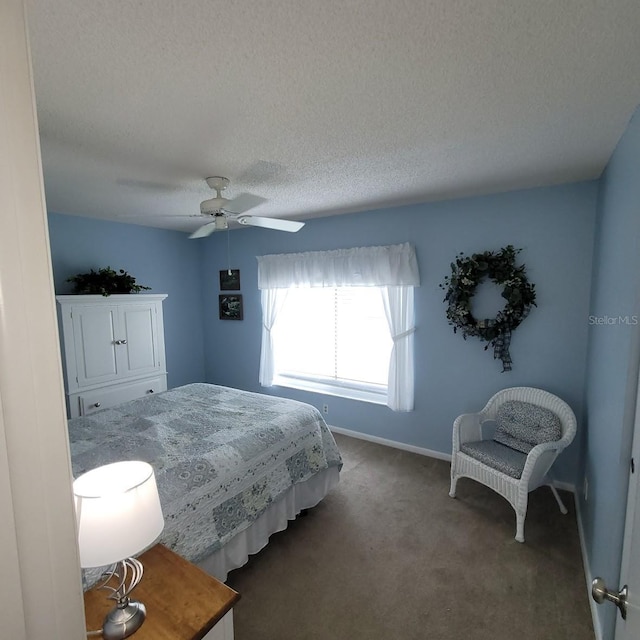 bedroom with dark carpet, a textured ceiling, and ceiling fan