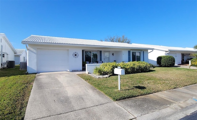 single story home with a garage, central AC, and a front yard