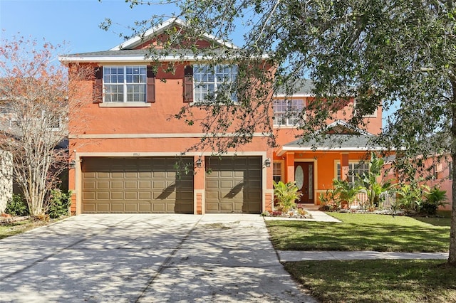 view of front of house featuring a front yard and a garage