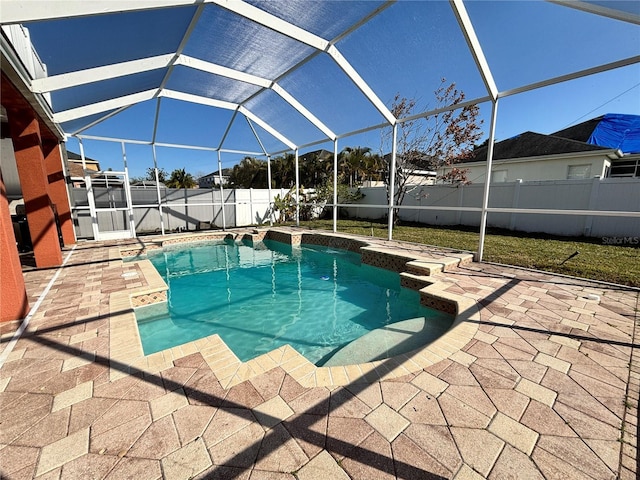 view of swimming pool featuring a patio and glass enclosure