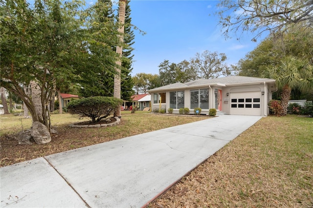 single story home featuring a front yard and a garage