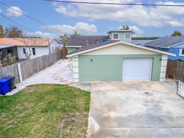 view of front of property featuring a garage and a front lawn