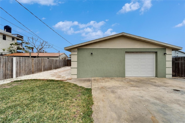 view of side of property featuring an outbuilding, a lawn, and a garage