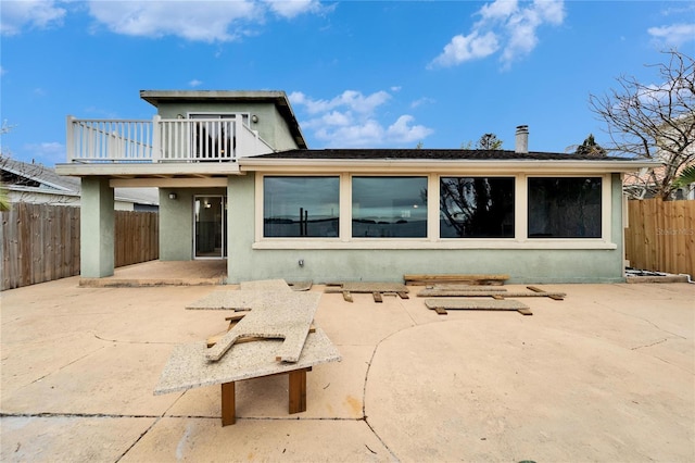 1022 Canal St, Ruskin, FL 33570 - rear view of house featuring a patio area, stucco siding, a balcony, and a fenced backyard