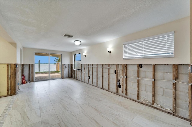1022 Canal St, Ruskin, FL 33570 - empty room with a textured ceiling