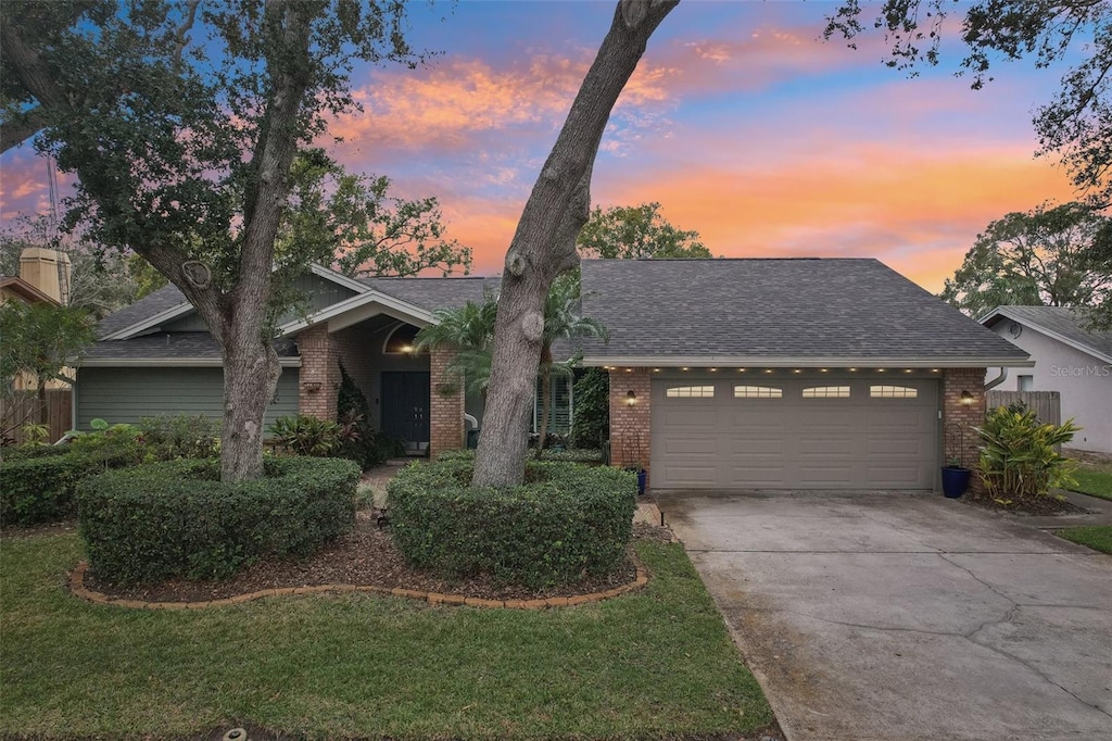 view of front of house with a garage and a lawn