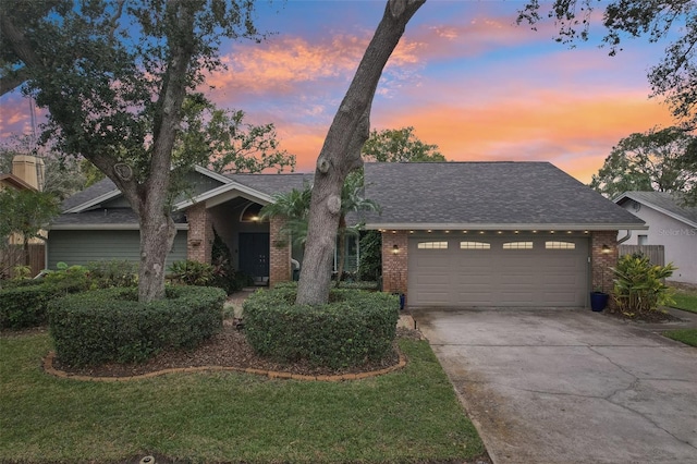 view of front of house with a garage and a lawn