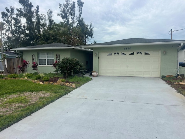 single story home featuring a front lawn and a garage