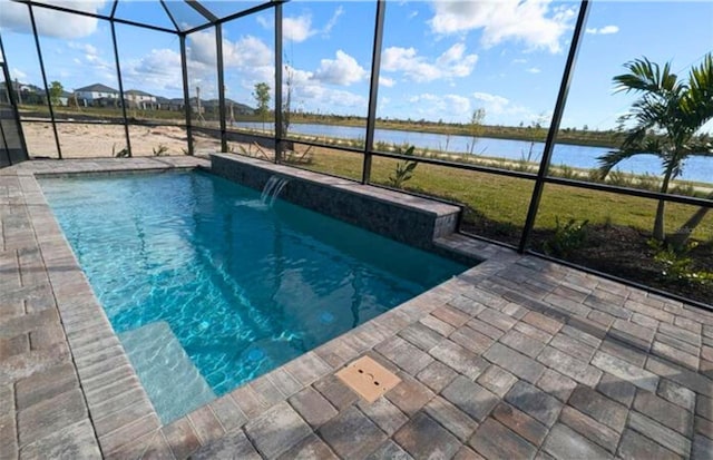 view of pool featuring pool water feature, glass enclosure, and a water view