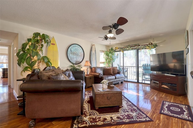 living room featuring ceiling fan, a textured ceiling, and hardwood / wood-style floors