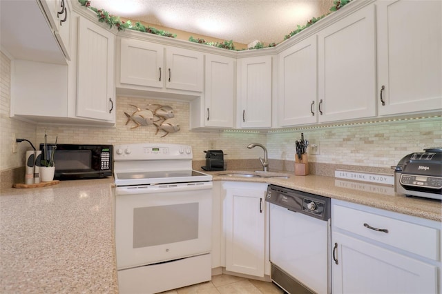 kitchen with light tile patterned floors, white cabinetry, decorative backsplash, white appliances, and sink