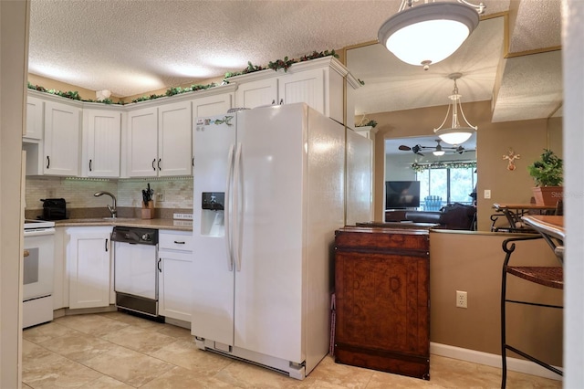 kitchen featuring white cabinetry, white appliances, pendant lighting, and a textured ceiling