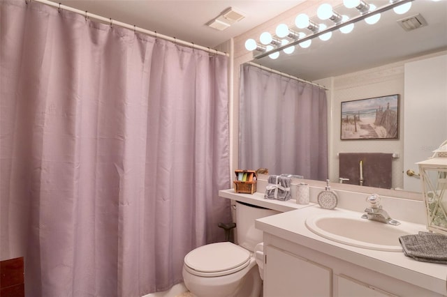 bathroom with toilet and vanity