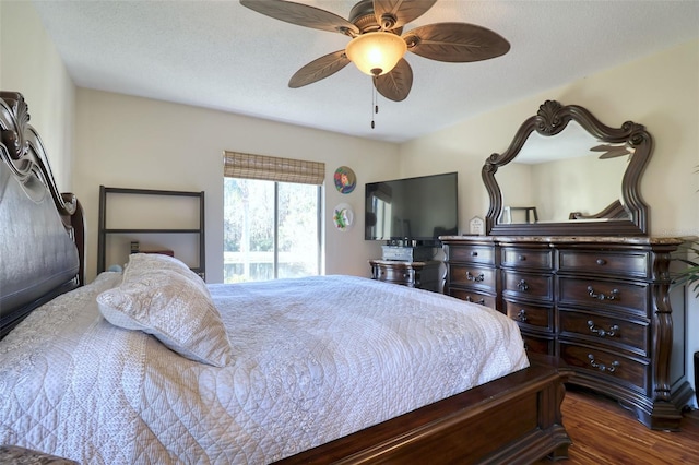 bedroom with ceiling fan, dark hardwood / wood-style flooring, and a textured ceiling