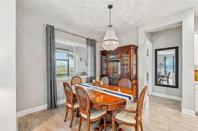 dining room featuring an inviting chandelier and light hardwood / wood-style flooring