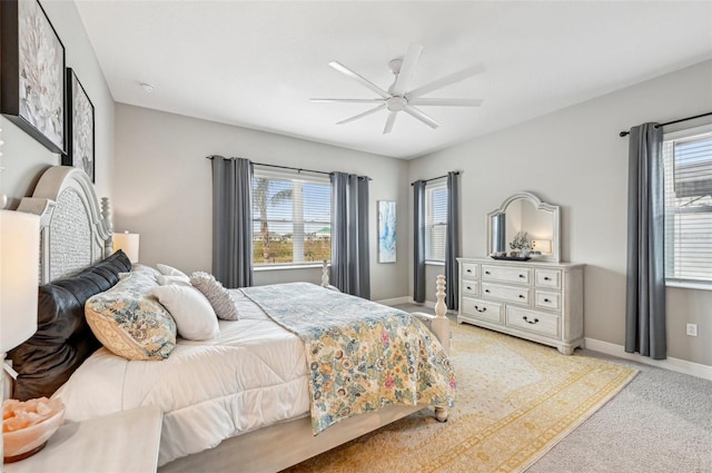 bedroom featuring ceiling fan and light carpet