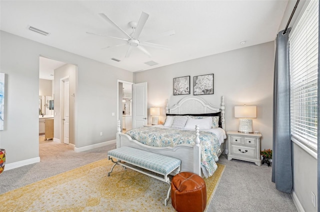 carpeted bedroom featuring connected bathroom and ceiling fan