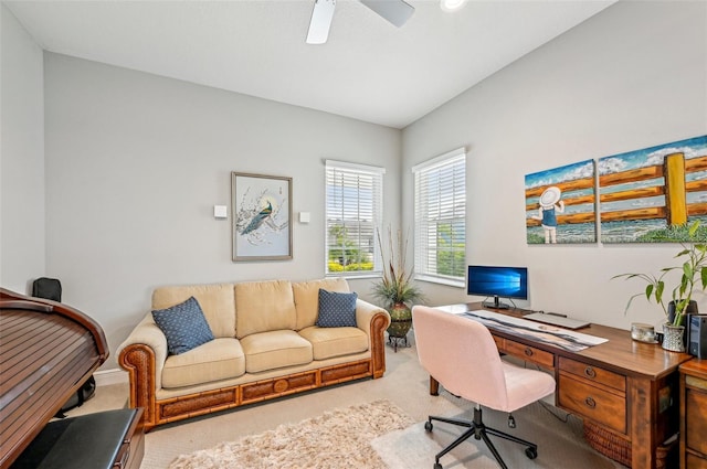 carpeted office featuring ceiling fan