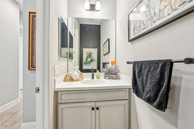 bathroom with vanity and hardwood / wood-style floors