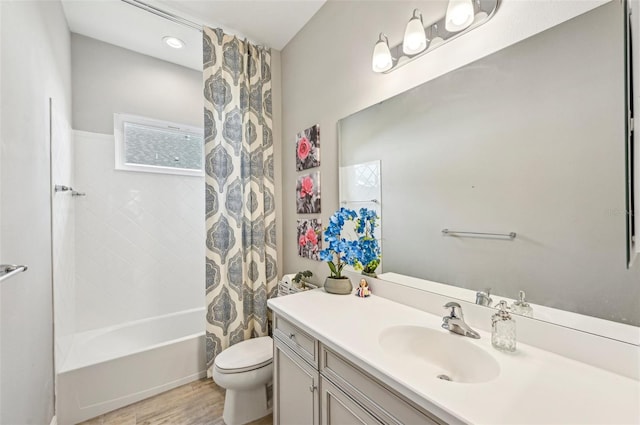 full bathroom featuring vanity, wood-type flooring, toilet, and shower / tub combo with curtain