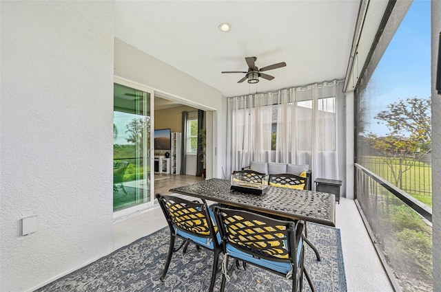 sunroom / solarium featuring ceiling fan