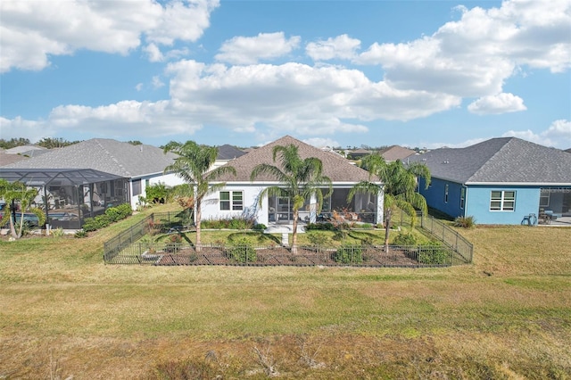 view of front of house with a lanai and a front lawn