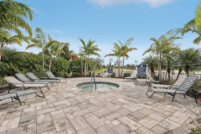 view of swimming pool featuring a patio area and a community hot tub