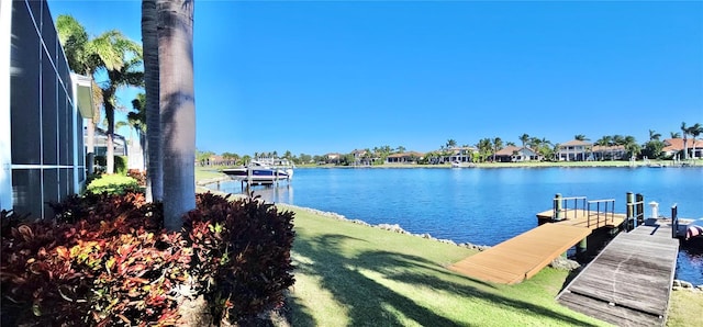 view of dock featuring a yard and a water view