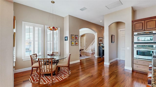 dining room with a wealth of natural light and dark hardwood / wood-style floors