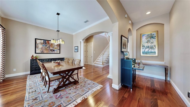 dining area with dark hardwood / wood-style floors and ornamental molding