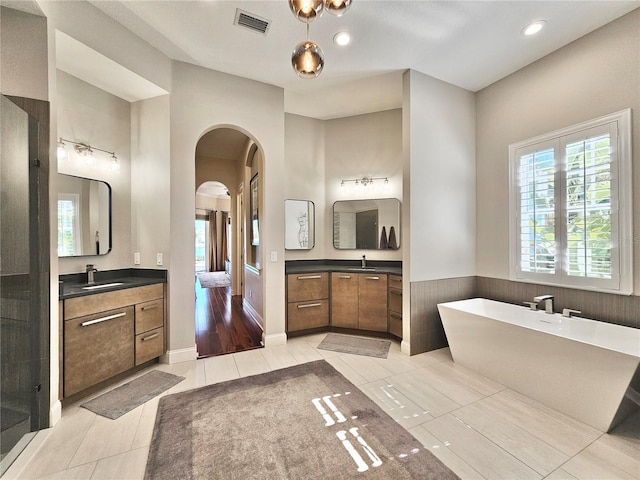 bathroom with tile patterned flooring, shower with separate bathtub, and vanity