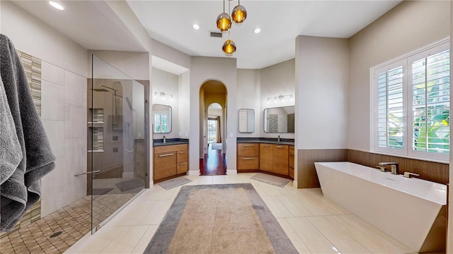 bathroom featuring tile patterned flooring, vanity, and separate shower and tub