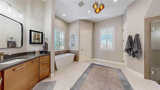 bathroom featuring tile patterned floors, vanity, and a healthy amount of sunlight