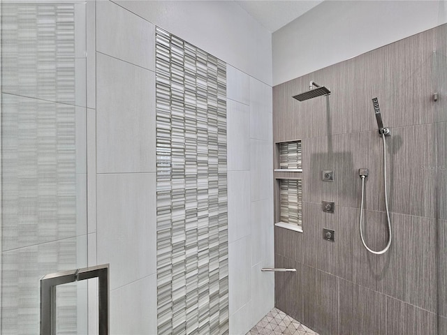 bathroom with tiled shower