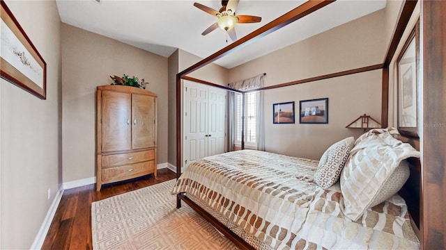 bedroom with a closet, ceiling fan, and dark wood-type flooring