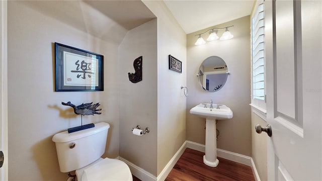 bathroom featuring hardwood / wood-style flooring, toilet, and lofted ceiling