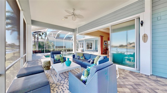 sunroom / solarium featuring ceiling fan