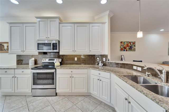 kitchen with stainless steel appliances, white cabinetry, hanging light fixtures, and sink