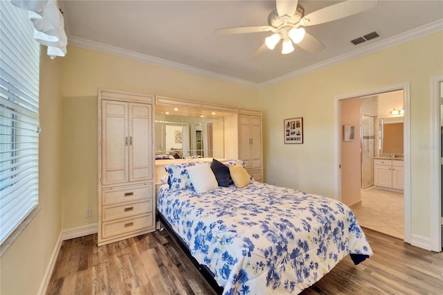 bedroom featuring ceiling fan, ornamental molding, connected bathroom, and hardwood / wood-style floors