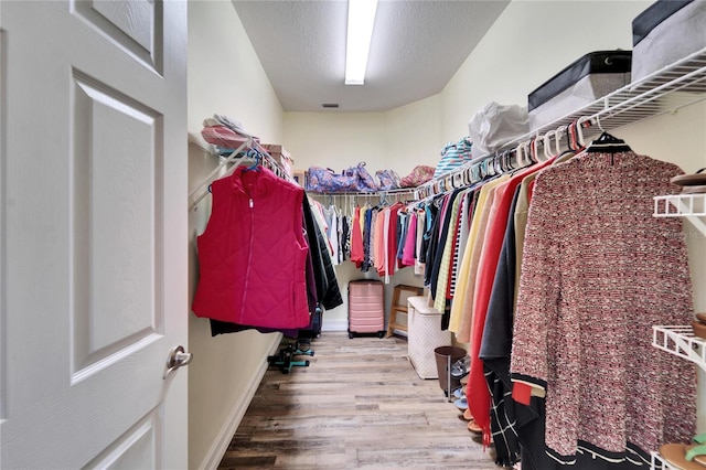 spacious closet featuring hardwood / wood-style floors